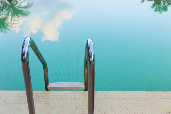 Scala in acciaio di piscina verde con riflesso del cielo — Foto Stock