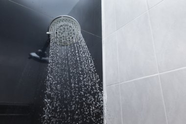 shower head in bathroom with water drops flowing clipart