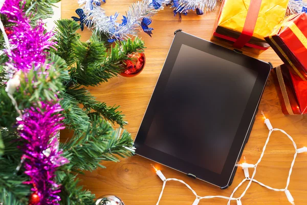Black tablet on table wood with christmas decoration — Stock Photo, Image