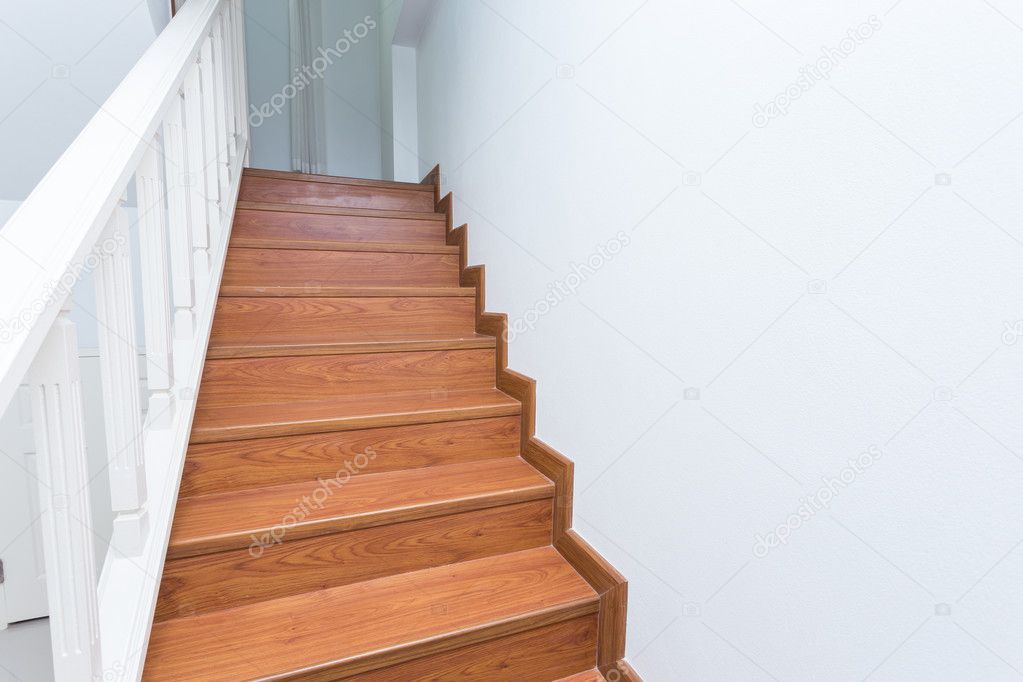 wooden staircase made from laminate wood in white modern house