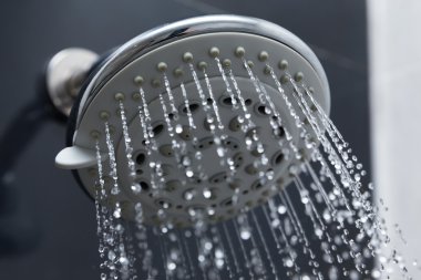 shower head in bathroom with water drops flowing clipart