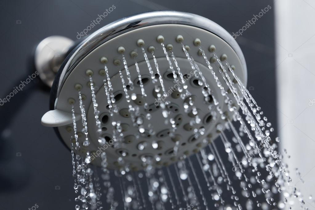 Shower head in bathroom with water drops flowing — Stock Photo
