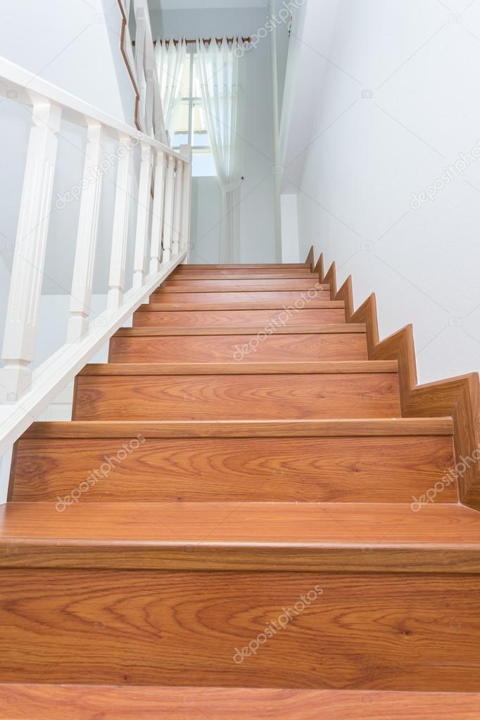 wooden staircase made from laminate wood in white modern house