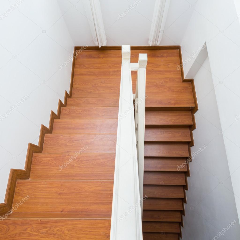 wooden staircase made from laminate wood in white modern house