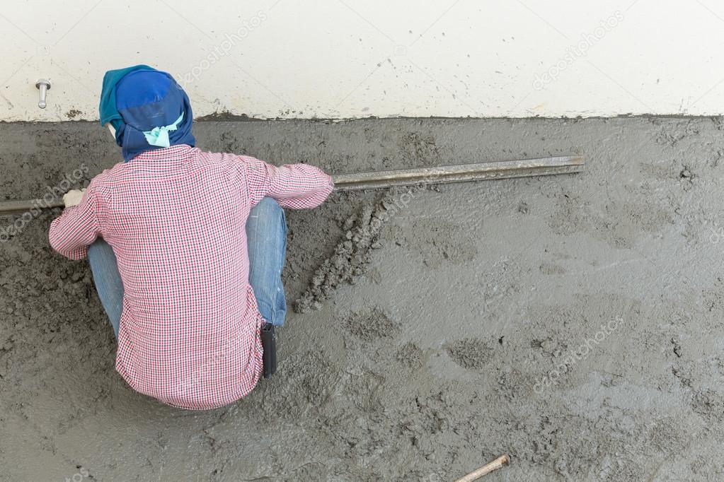 plasterer concrete cement worker plastering flooring of house co