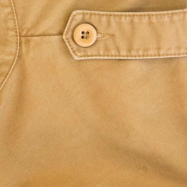 Texture de tissu brun avec bouton sur le matériau de l'industrie textile — Photo