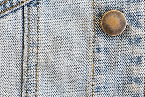 Jeans denim abbigliamento con bottone metallico su indumenti tessili indus — Foto Stock