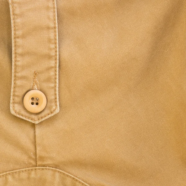 Texture de tissu brun avec bouton sur le matériau de l'industrie textile — Photo