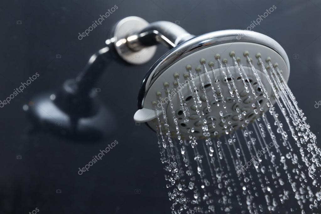 Shower head in bathroom with water drops flowing — Stock Photo