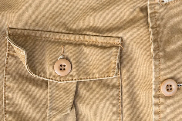 Front pocket on brown shirt textile texture background — Stock Photo, Image