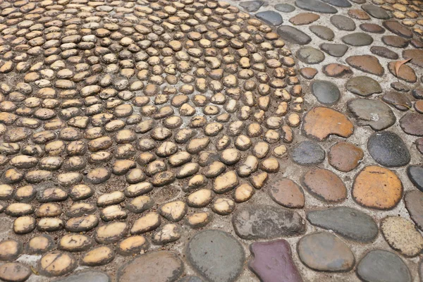 Small pebble brown stone decorated floor — Stock Photo, Image