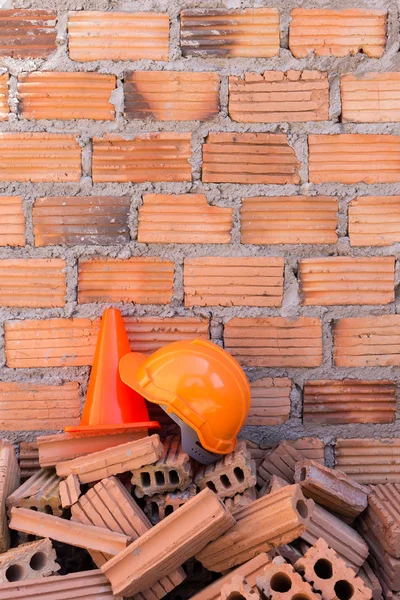 Construction helmet safety and cone in construction site with br — Stock Photo, Image