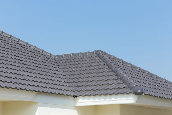 black roof tiles on house with blue sky