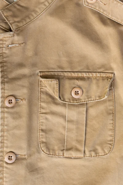 Front pocket on brown shirt textile texture background — Stock Photo, Image