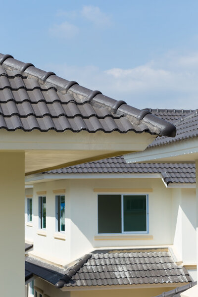 black roof tiles on house with blue sky