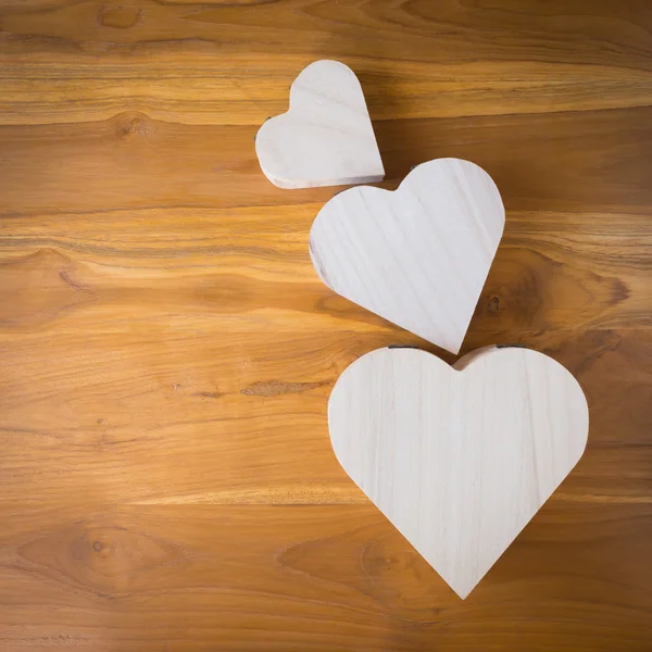 Wood box shaped heart on brown wooden background — Stock Photo, Image