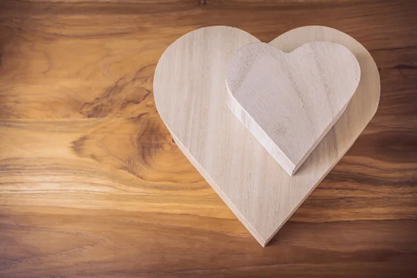 Caja de madera en forma de corazón sobre fondo de madera marrón —  Fotos de Stock