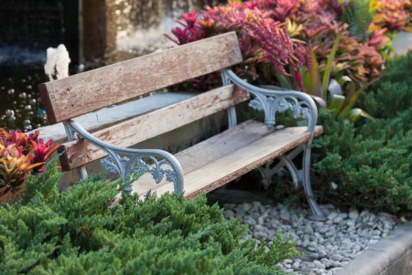 old vintage bench in flowers garden
