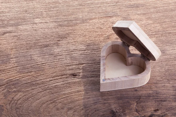 Heart brown wood box on wood background, abstract love