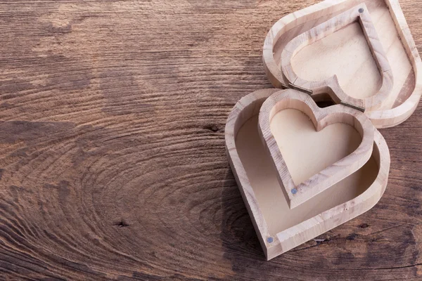 Heart brown wood box on wood background, abstract love