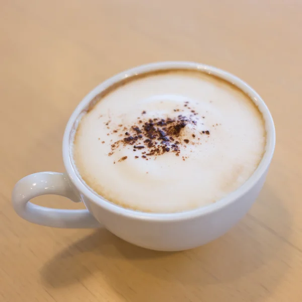 Hot coffee on wooden table in the cafe — Stock Photo, Image