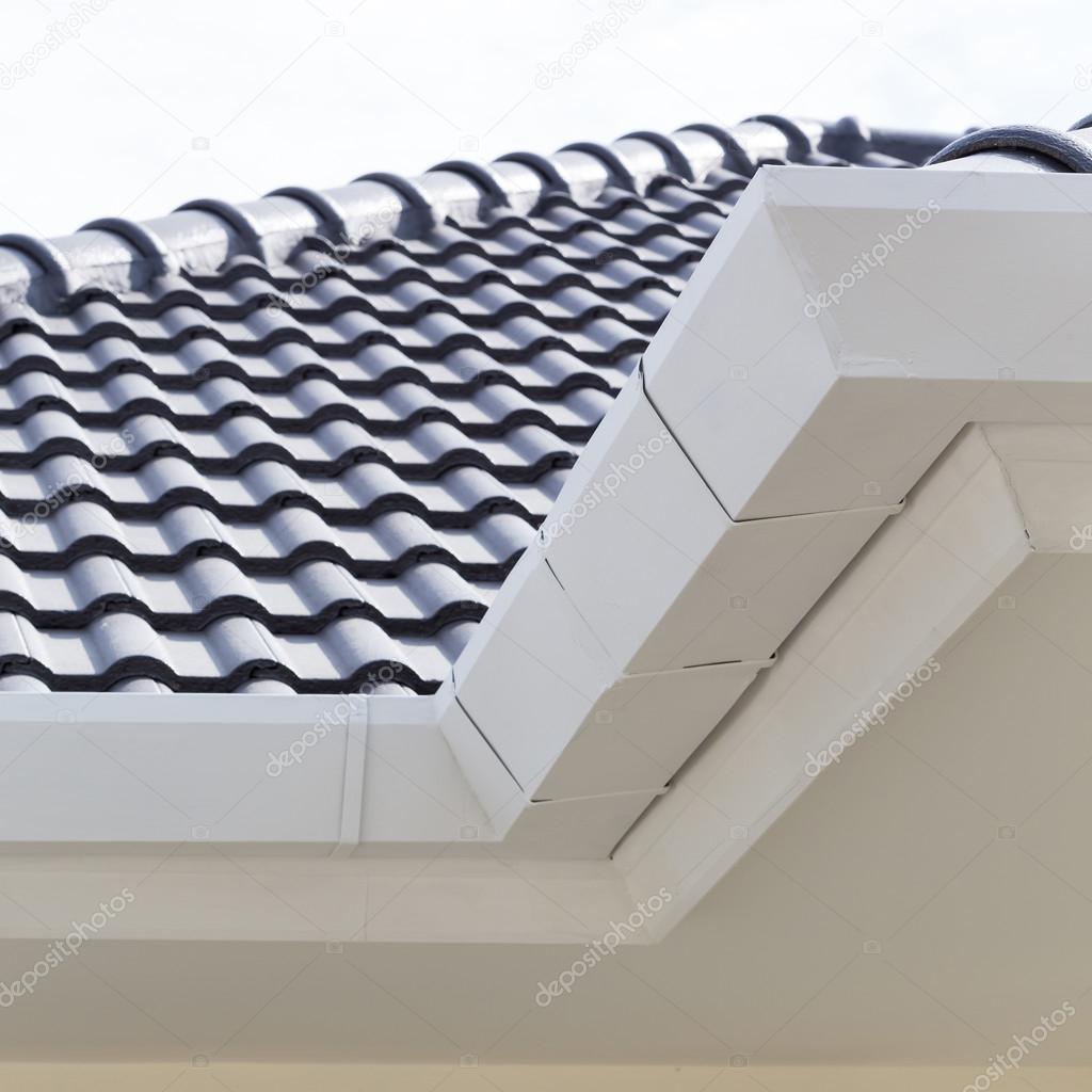 white gutter on the roof top of house