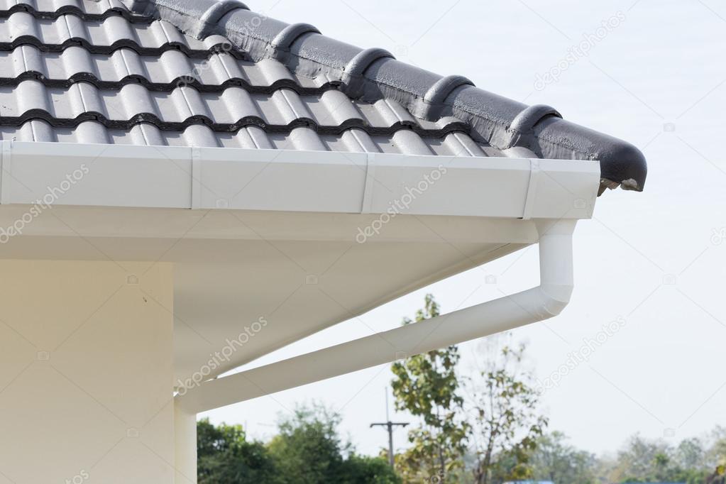 white gutter on the roof top of house