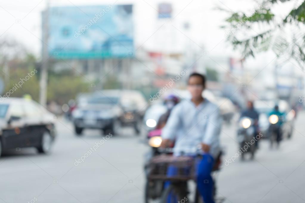 Car and motorcycle driving on road with traffic jam in the city