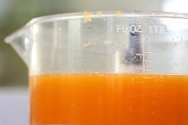 Zumo de naranja fresco en la máquina de juicer con mano — Foto de Stock
