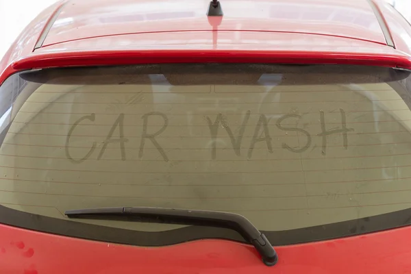 Text of car wash on back mirror dirty car Stock Picture
