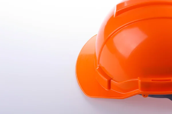 Orange safety helmet hard hat, tool protect worker of danger — Stock Photo, Image