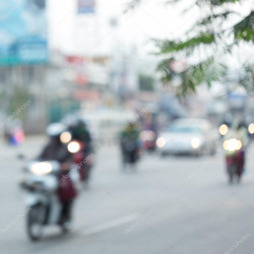 car and motorcycle driving on road with traffic jam in the city