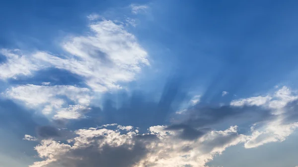 light of sunbeam on blue sky background with clouds