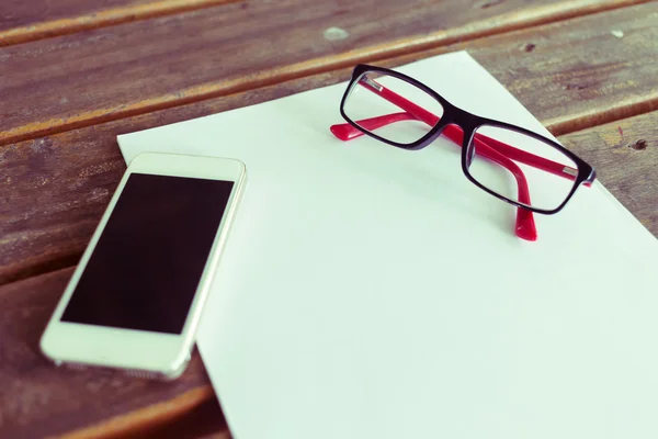 top view of creative workspace with white paper blank and mobile