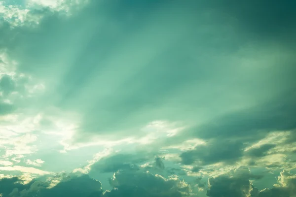 Light of sunbeam on blue sky background with clouds — Stock Photo, Image