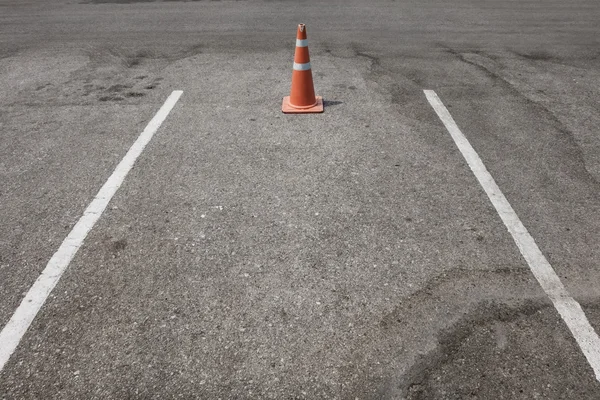 Parking lot with traffic cone on street used warning sign — Stock Photo, Image