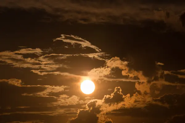 Orange sky with sun and black clouds — Stock Photo, Image