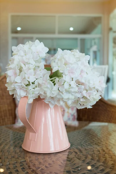 Fleurs en plastique blanc en vase rose sur le tissu de rotin — Photo
