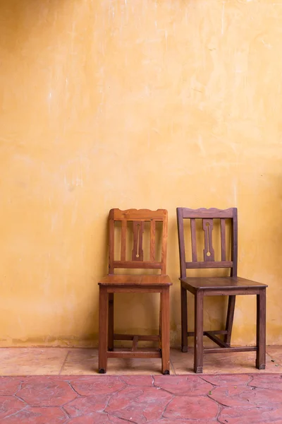 wooden chair and cement mortar wall background