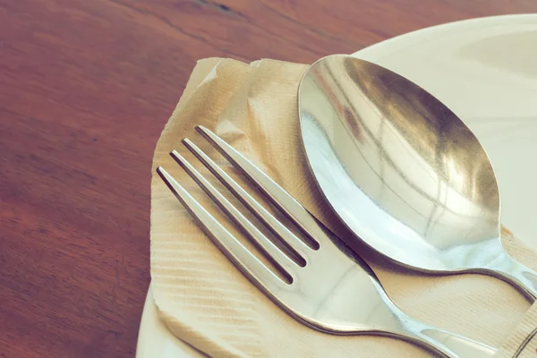 Dishware set on wood table with plate, spoon and fork — Stock Photo, Image