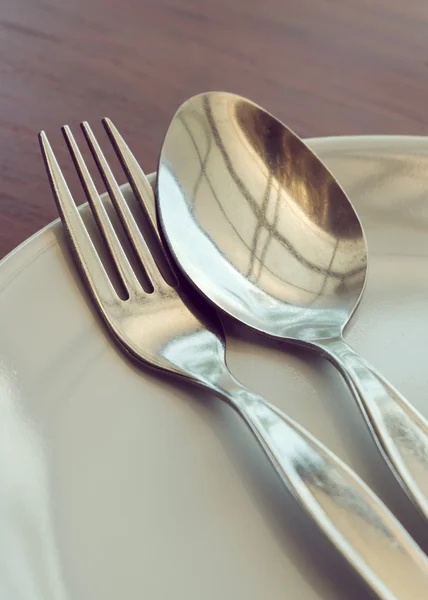 Dishware set on wood table with plate, spoon and fork — Stock Photo, Image