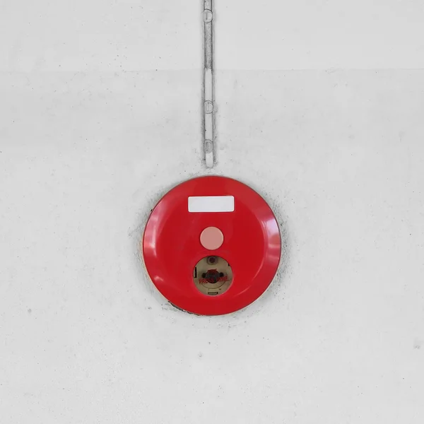 red fire alarm box for warning security system mounted on wall