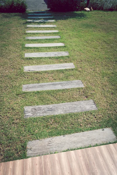 Sten gångstig trottoaren på grönt gräs trädgård — Stockfoto