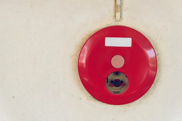 Red fire alarm box for warning security system mounted on wall Stock Photo