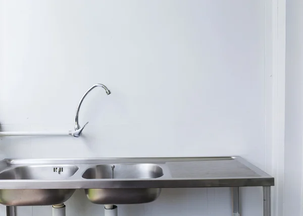 Stainless steel sink and faucet in white kitchen room — Stock Photo, Image