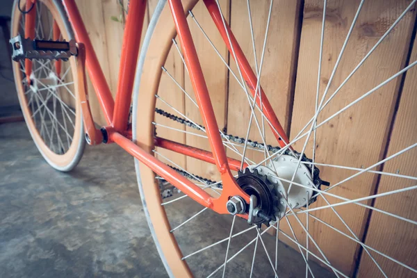 Bicicleta de engrenagem fixa estacionada com parede de madeira, imagem de close-up — Fotografia de Stock