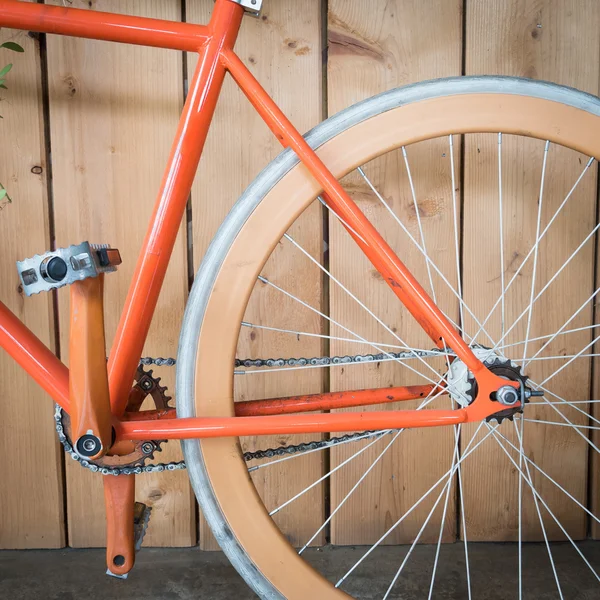 fixed gear bicycle parked with wood wall, close up image