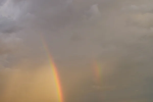 雨の雲の夕焼け空にカラフルな虹 — ストック写真