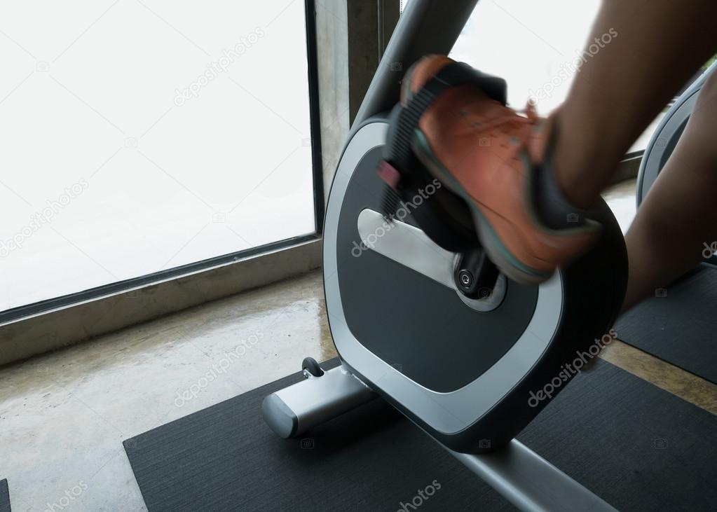 woman exercise riding bicycle in fitness center