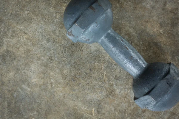 Metal dumbbell on cement floor, fitness sport of bodybuilding — Stock Photo, Image